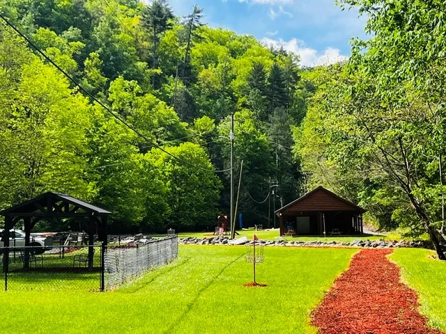 The Shagbark community park showing a covered pavilion, fenced court, open lawn and picnic shelter