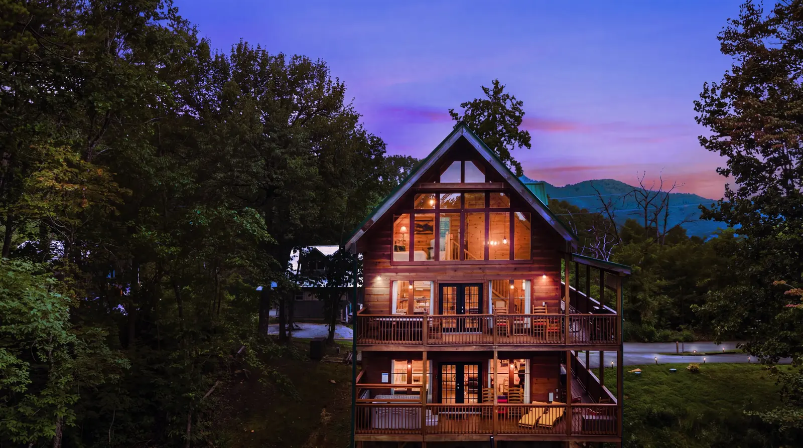 Acorn Ridge cabin lit from within at dusk